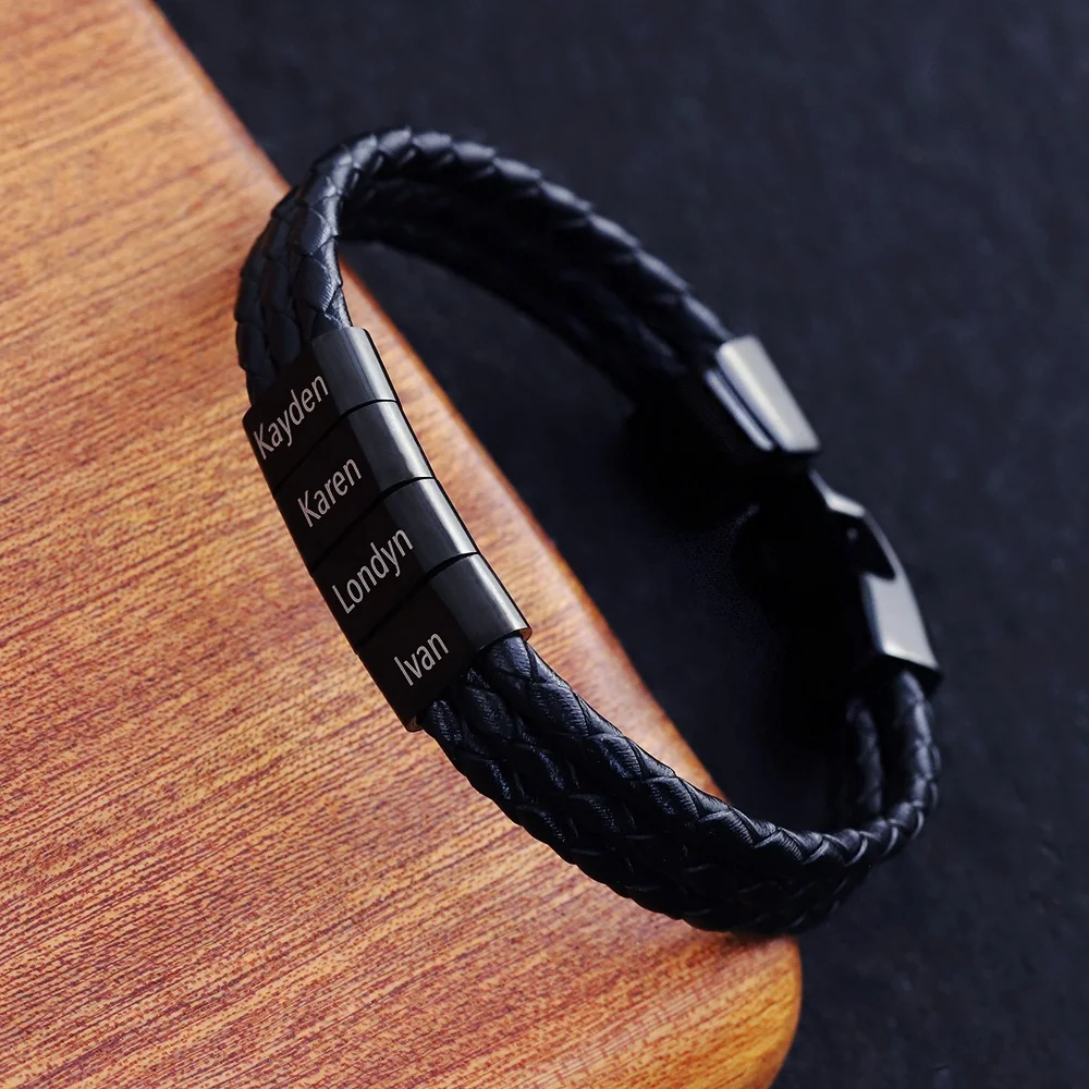 Dark braided bracelet with four dark name elements, photographed on wood